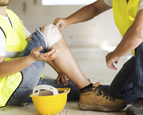 A man getting a band aid for a construction accident